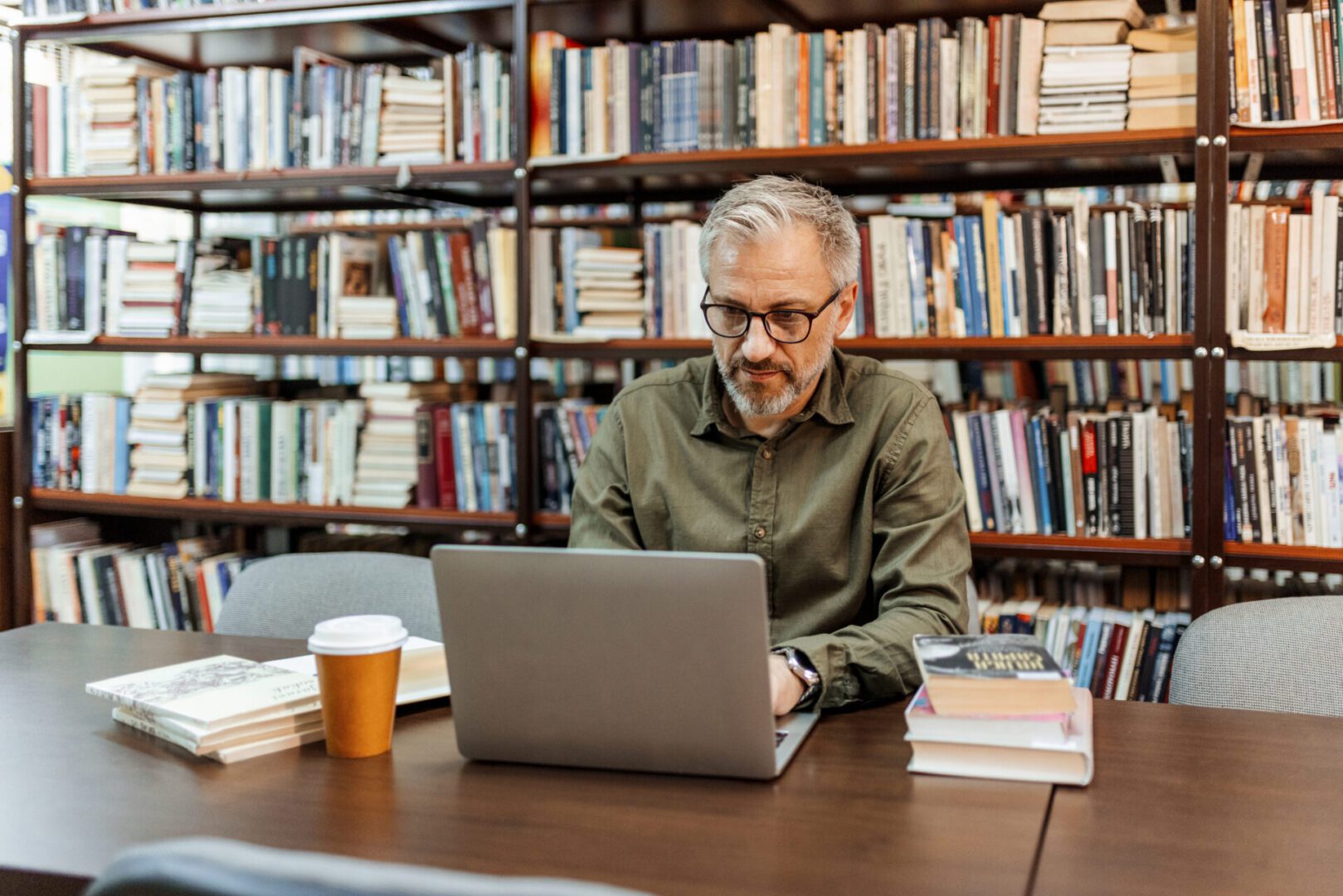 Man working on laptop in library