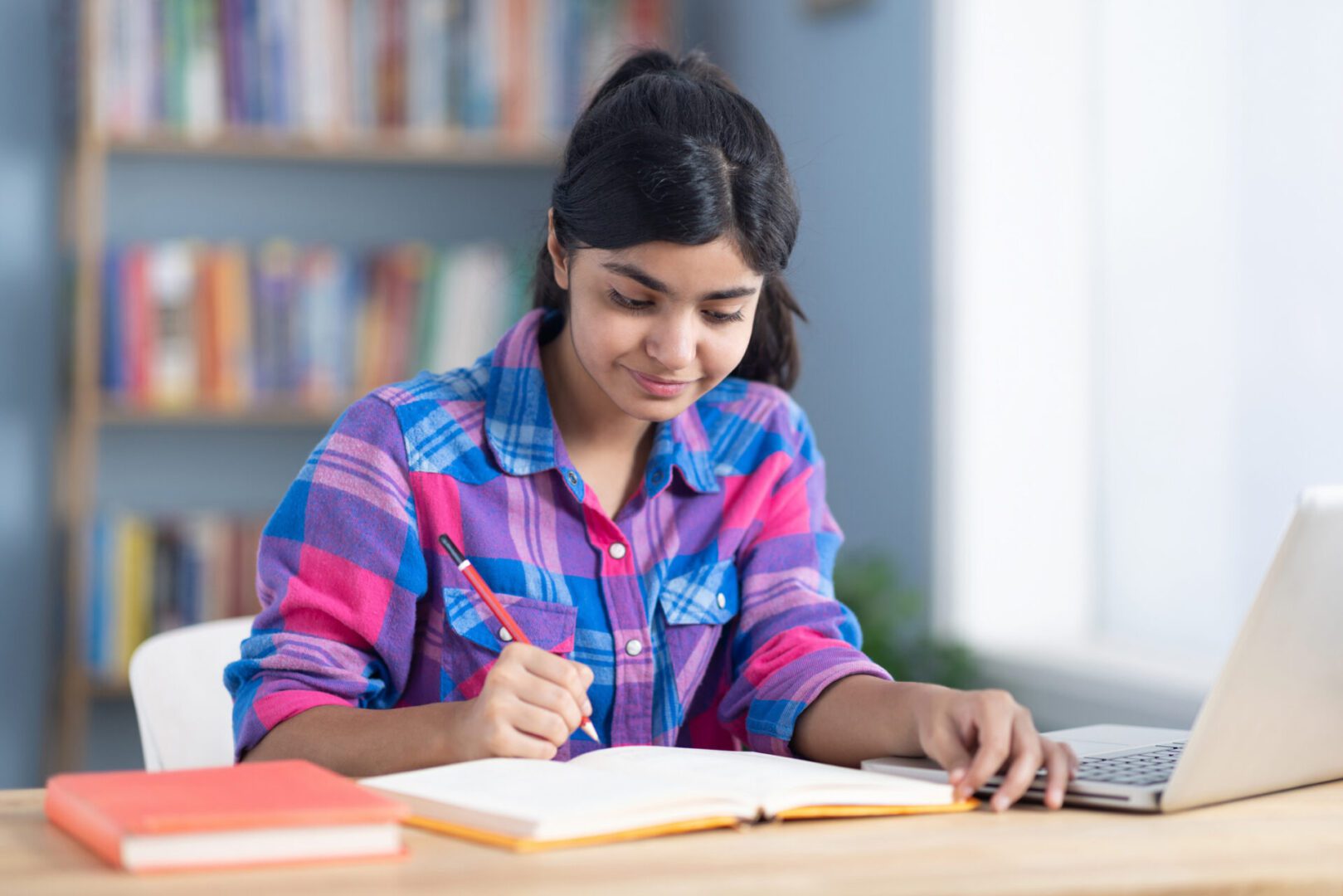 Girl focused on homework in library