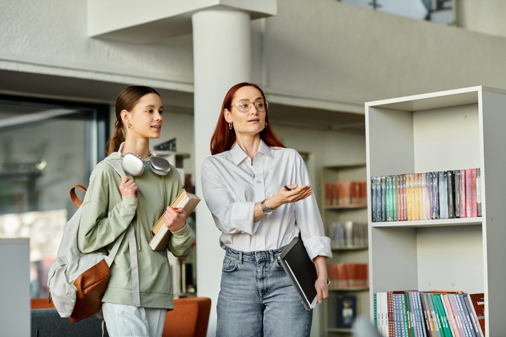 Woman guiding student with books